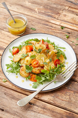 Herb roasted potatoes with arugula salad