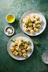Homemade potato gnocchi with basil and chilli