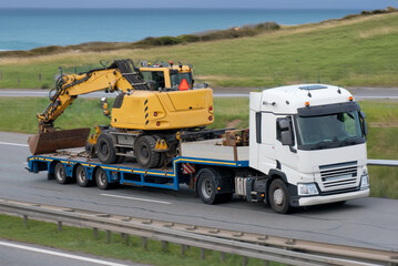 Heavy-Lift Semi-Truck Transporting Large Excavator on Flatbed Trailer