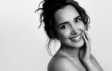 Beautiful young woman with pretty  smile and flawless skin after skincare