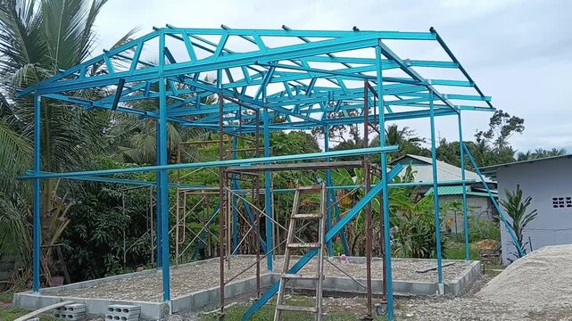 
Construction of a new house with blue metal  roof trusses on the groundin kluang, johor, malaysia,constructed with iron and metal
