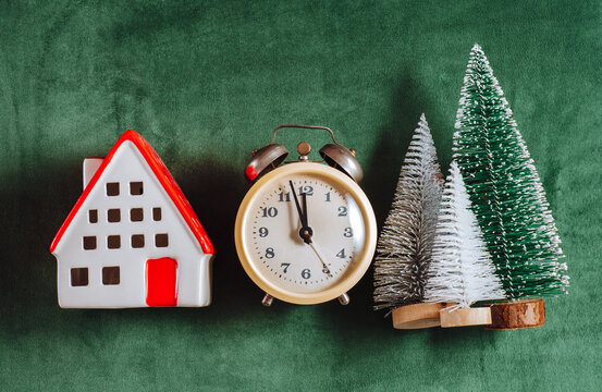 Christmas and New Year symbol with house clock and tree on green velvet