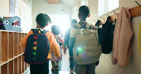 Back, kids and students with backpack in lobby at school, education and recess break. Pupil,...
