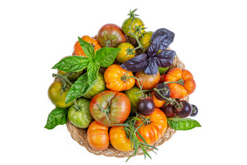 Colorful heirloom tomatoes on display on white background