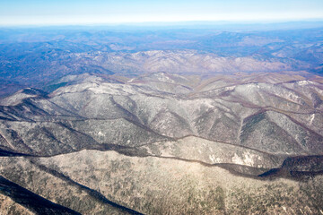 Aerial view. Golden autumn in Primorsky Krai. The Sikhote-Alin mountain range from above.