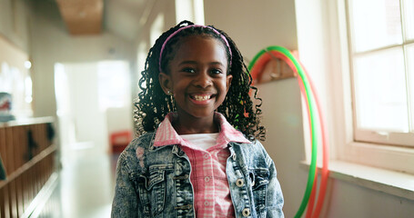 Black child, portrait and happy in hallway for education, learning opportunity or back to school. Kid, excited or knowledge at montessori for development, growth and academic scholarship in Nigeria
