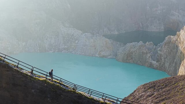 Aerial view of the stunning Kelimutu lakes displaying a mesmerizing spectrum of colors, framed by rugged cliffs, Kelimutu, East Nusa Tenggara, Indonesia.