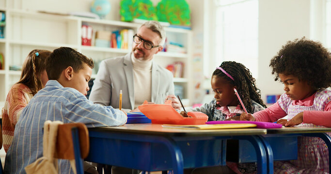 Elementary, teacher and man with children, writing or helping students with assignment or education. Knowledge, growth and development of kids in classroom, educator and teaching learner in school