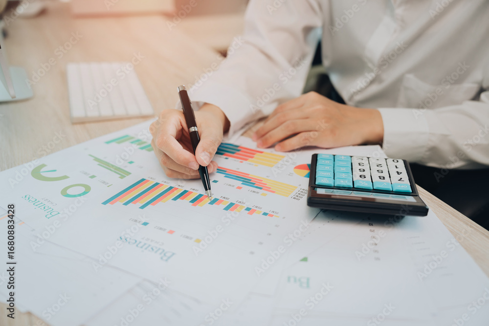 Poster detailed analysis of business performance with data charts and calculators in modern office setting