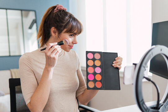 Vlogger recording make-up tutorial at home