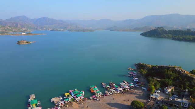 Aerial view of boats docked at the shore of Khanpur Lake, with mountains in the background, Khanpur, Khyber Pakhtunkhwa, Pakistan.