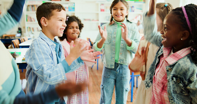 Education, kids and applause in classroom together for learning, growth or development. Energy, smile and happy student children in back to school class for knowledge, excited friends and academics