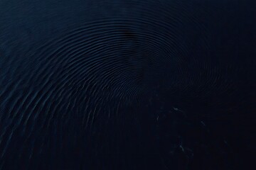 Dark, swirling ripples on a deep blue surface
