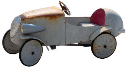 Old vintage metal ride-on toy sports car worn out with rust spots. Isolated on transparent PNG white background.