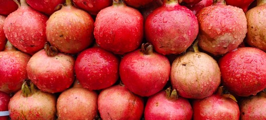 Close up shot of pile of fresh Raindrops on a pomegranate.