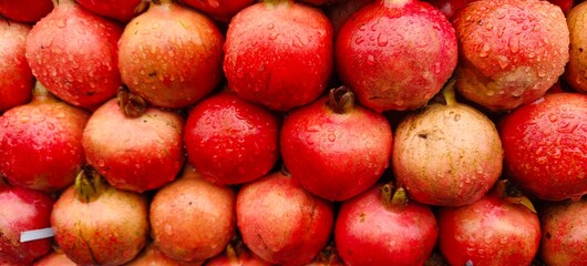 Close up shot of pile of fresh Raindrops on a pomegranate.