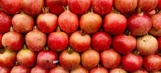 Close up shot of pile of fresh Raindrops on a pomegranate.
