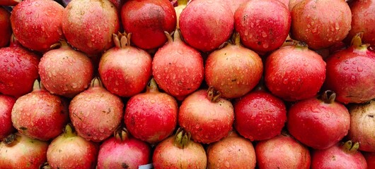 Close up shot of pile of fresh Raindrops on a pomegranate.
