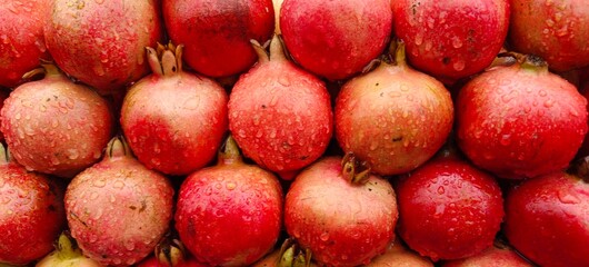 Close up shot of pile of fresh Raindrops on a pomegranate.
