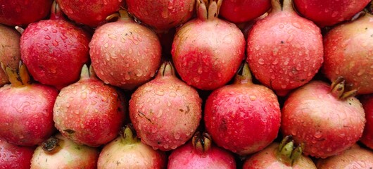 Close up shot of pile of fresh Raindrops on a pomegranate.