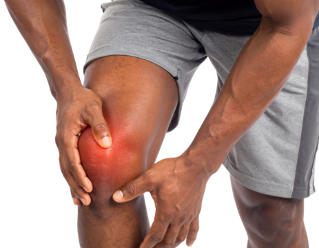 A person experiencing knee pain, holding their knee while wearing athletic shorts, indicating discomfort or injury. - Powered by Adobe