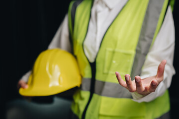 Construction Worker Gesturing with Safety Vest and Yellow Hard Hat for Industrial and Engineering...