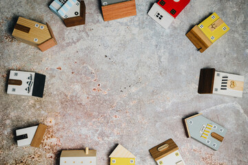 Colorful Wooden Toy Houses Arranged in a Circular Pattern on a Rustic Surface for Creative Play and Learning Activities
