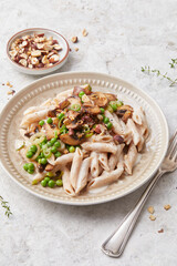 Pasta with peas and hazelnuts