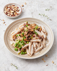 Pasta with peas and hazelnuts