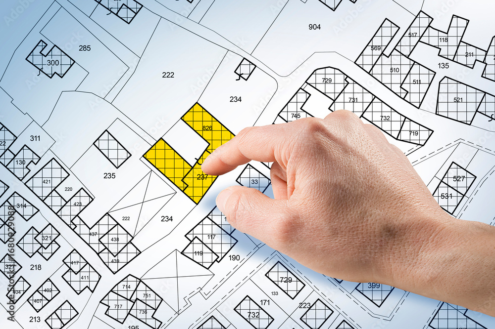 Poster real estate property map with hand selecting land plot on cadastral map - concept of investment, dev