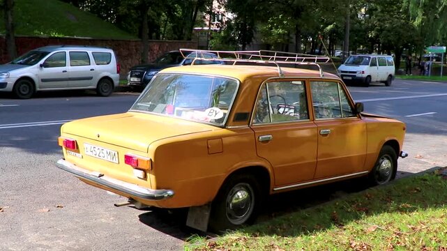 Old Russian orange classic vintage car vehicle in Minsk Belarus.