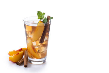 Refreshing peach iced tea in glass with ice cubes and cinnamon isolated on white background. Copy space