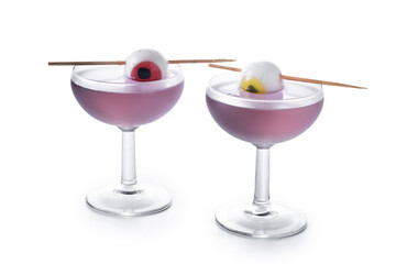 Purple Halloween cocktail garnished with candy eye isolated on white background