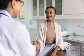 Obraz premium Satisfied patient shaking hands with doctor, getting professional medical consultation