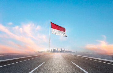 Monaco national flag with mast waving with beautiful skyline. A view from highway. Monaco flag for...