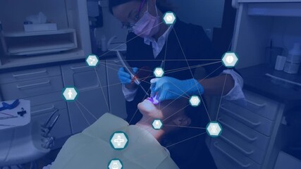 Network of digital icons over african american female dentist examining female patient's teeth - Powered by Adobe