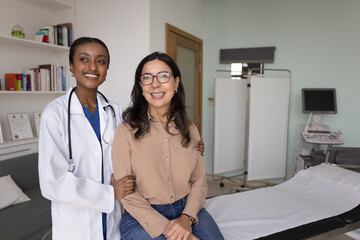 Doctor and patient posing together in modern medical office