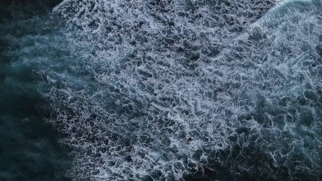 Aerial View of Crashing Ocean Waves on a Blue Sea