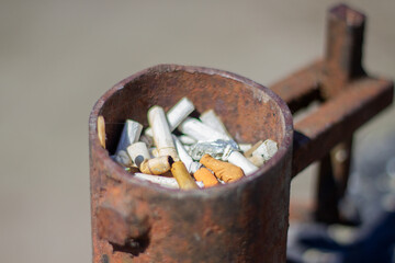 Discarded Remnants of a Busy Day Captured in a Rusty Container by the Roadside