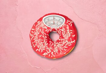 Classic weight scale on donut, food concept