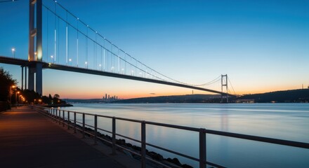 Fototapeta premium Bosphorus bridge at dusk with city skyline and calm water