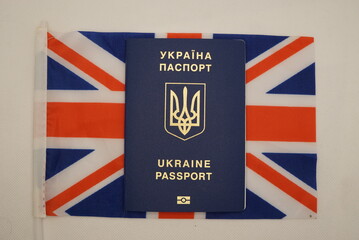 Fototapeta premium ukrainian citizen's passport with the british flag in the background