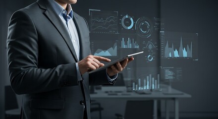Businessman interacting with a digital tablet displaying holographic data visualizations in a modern office environment.