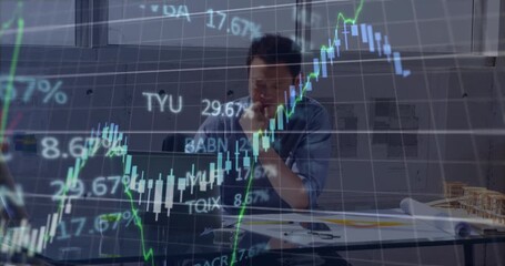 Stock market data processing over asian male engineer using laptop at office - Powered by Adobe