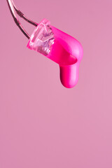 Magenta paint drop falling from led