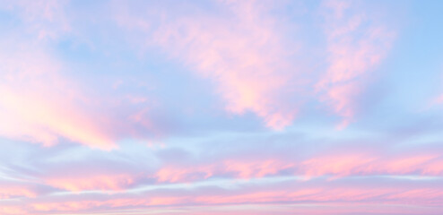 Beautiful pink and purple clouds in a blue sky at sunset or sunrise, dramatic colorful sky...