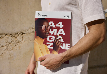 Mockup Of Man Holding A4 Magazine, Customizable