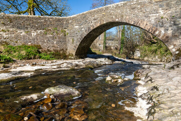 west burton village in the yorkshire dales national park north yorkshire england and the stone bridge over the walden beck blue sky no people