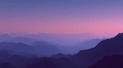 Obraz premium Misty Mountain Majesty: A tranquil display of mountain ranges fading into the distance, their peaks shrouded in a soft, atmospheric haze. The sky above gently shifts in shades of purple and pink.