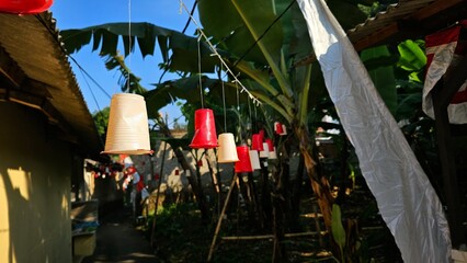 White and red plastic ornaments hanging on the tree in order to celebrate of Indonesia's Independence Day. Euphoria welcoming Indonesian Independence Day on 17 August 2025 .